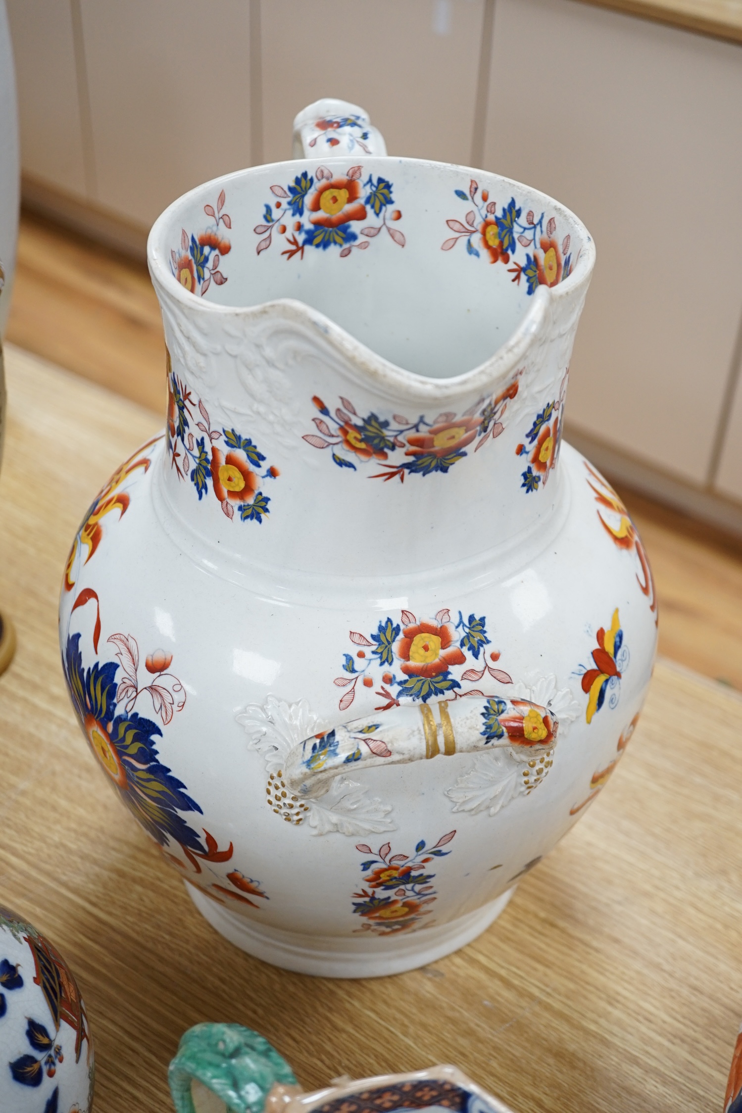 Five ironstone jugs to include a pewter mounted example, largest 36cm high. Condition - varies, poor to fair